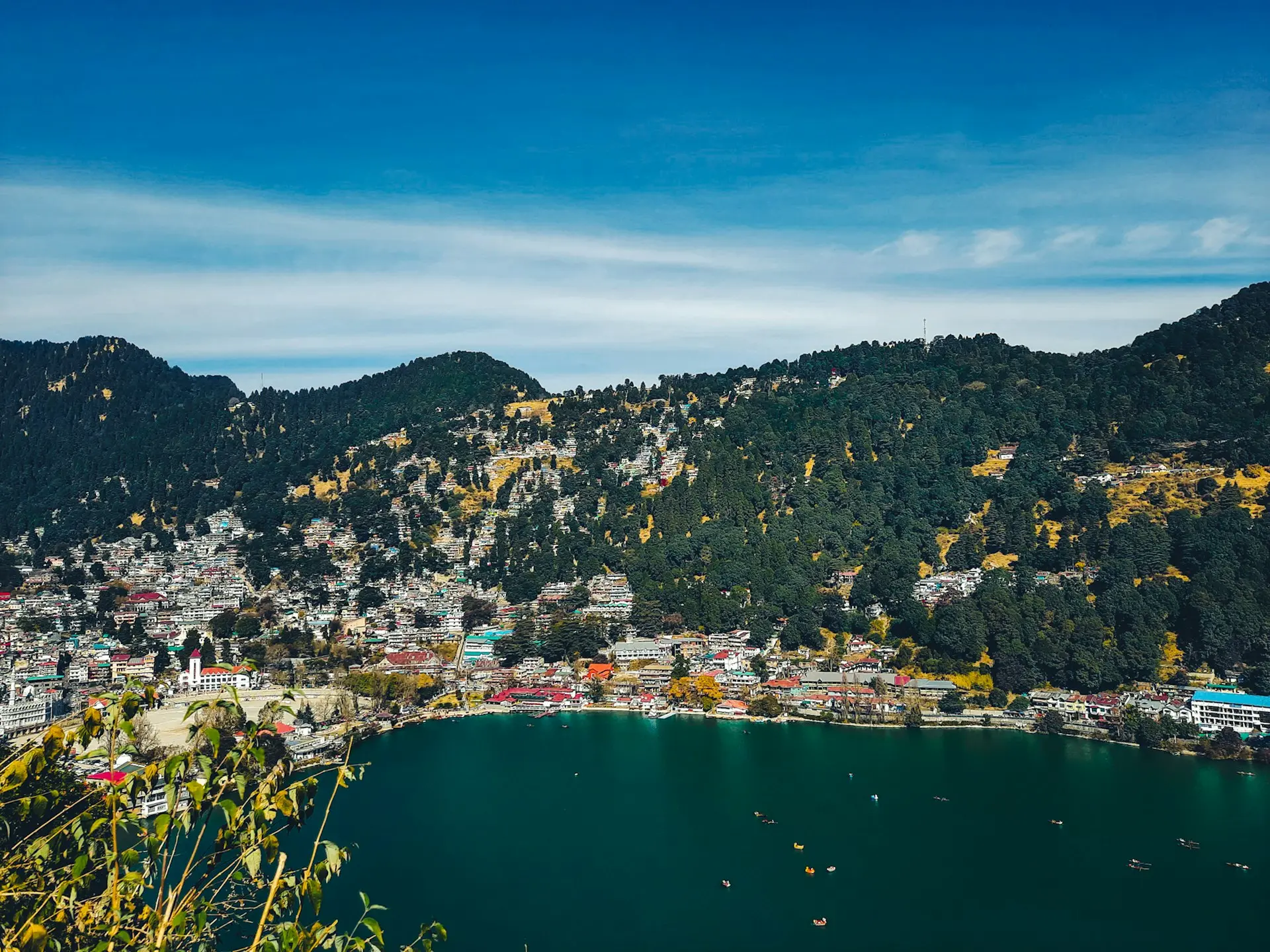 city near body of water under blue sky during daytime